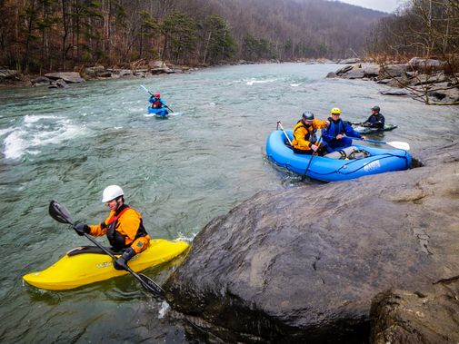 A group plays in the slack water below the Ledge Rapid (class III).