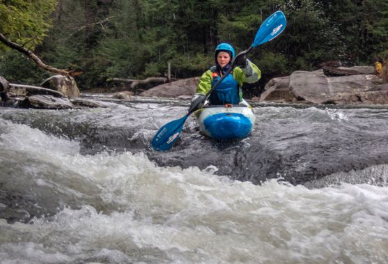 A kayaker paddles through a rapid on the Upper Big Sandy Creek