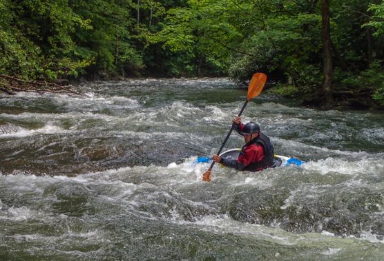 A kayaker surfs on the North Branch of the Potomac