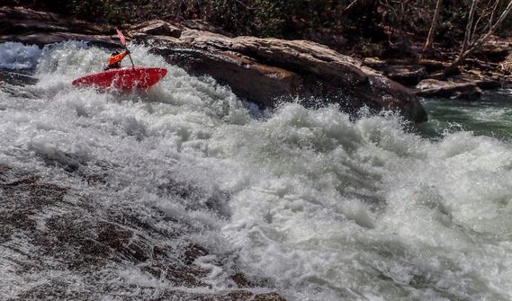A kayaker paddles through a rapid on the Tygart River Gorge
