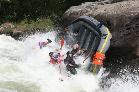 A raft flipping over at Pillow Rapid on the Upper Gauley River