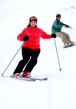 A skier and snowboarder come down a Canaan Valley slope