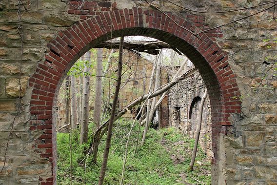 An arch frames the view of a church ruin