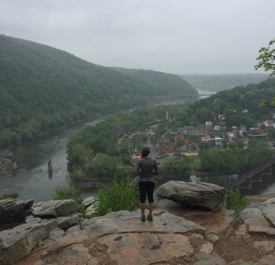 A hiker looks out over Harpers Ferry