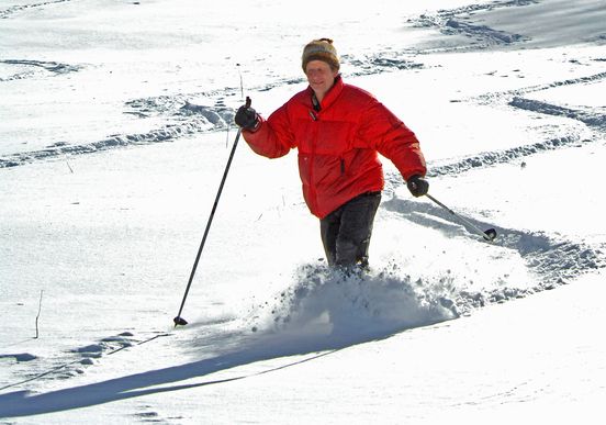 a telemark skier moving down the hill at Whitegrass