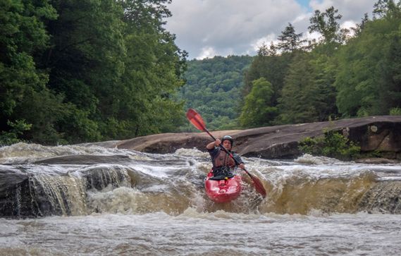 A kayaker drops over a ledge on the Upper Big Sandy Creek