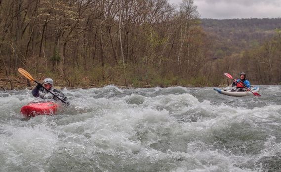 Two kayakers paddle through a rapid on the North Branch of the Potomac River