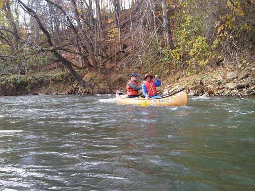 A canoe paddling down Dunkard Creek