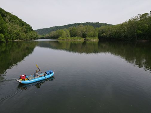 An inflatable kayak floats down the New River