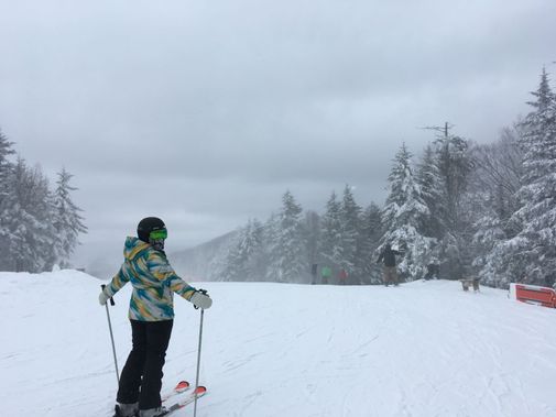 A skier gets ready to go down a slope