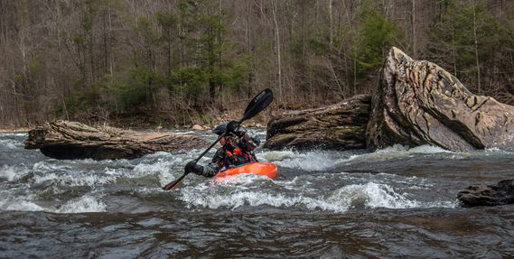 A kayaker paddles down the Dry Fork River