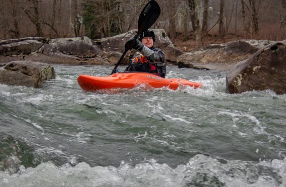 A kayaker paddles through a rapid on the Cherry River