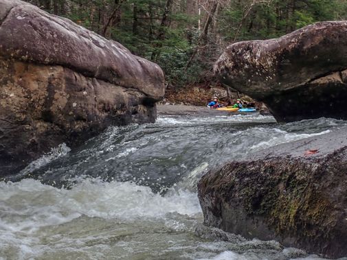 Kayakers get ready to go through a narrow drop on the Middle Meadow River