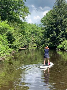 A person paddles on the Blackwater River