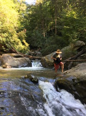 A canoer takes a break and explores waterfalls along Quarry Run