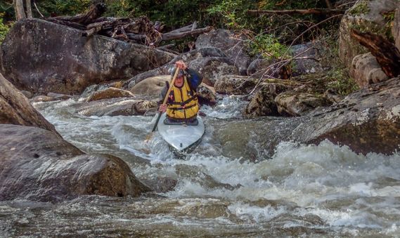 A kayaker paddles through a rapid on the Cranberry River