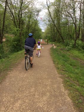 A father/daughter pair rides on the rail trail