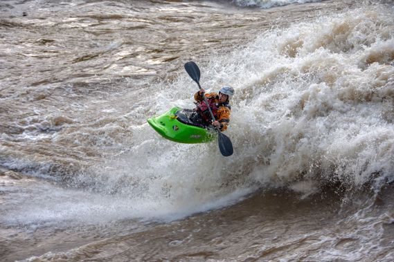 A kayaker surfs the New River Dries