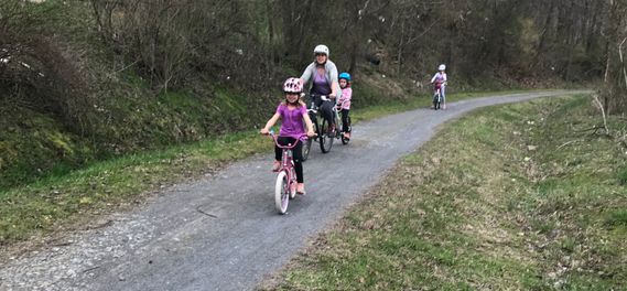 A family rides bikes on the Deckers Creek Trail