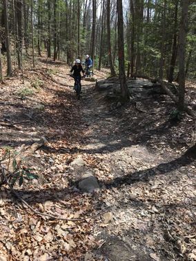Mountain bikers ride the Rhododendron Trail at Coopers Rock