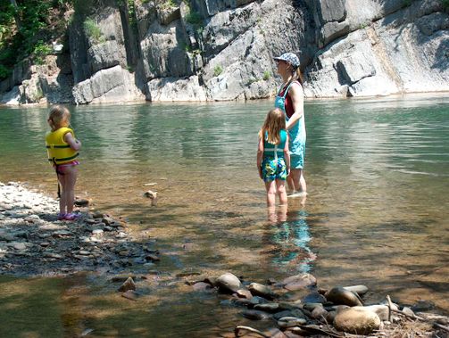 A mother and daughters wading at the swimming hole near Seneca Rocks