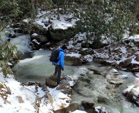 A person explores Otter Creek in the winter