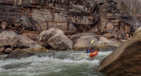 A kayaker paddles over a small drop on the New River Dries