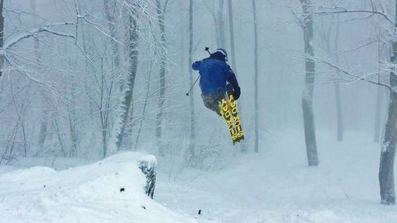 A skier goes off a jump at Seven Springs
