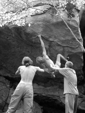 People bouldering and spotting at Camp 70 Boulders