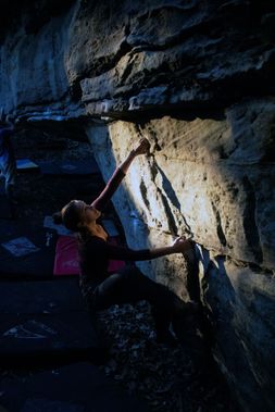 A climber starts a bouldering problem at Coopers Rock