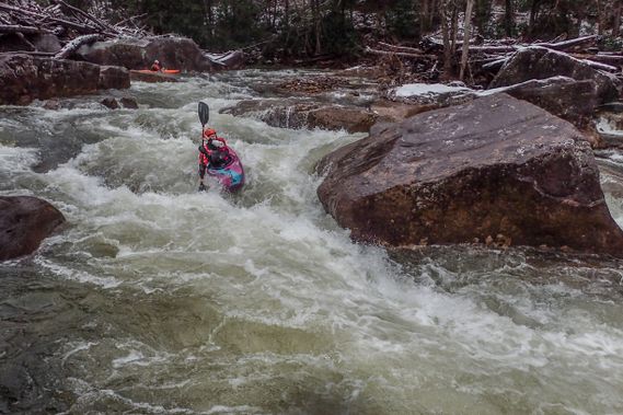 A kayaker paddles over a small drop on the Cranberry River
