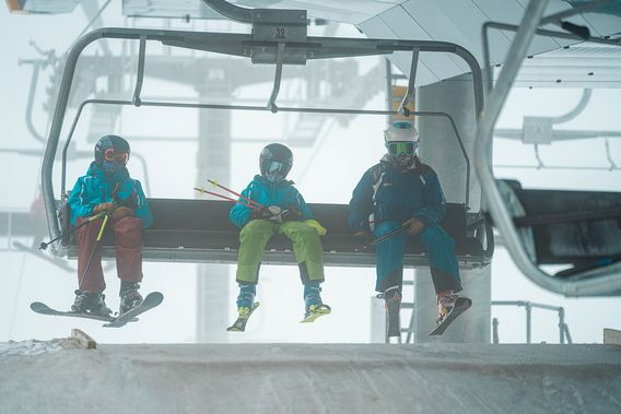 Skiers get ready to exit the lift at Timberline
