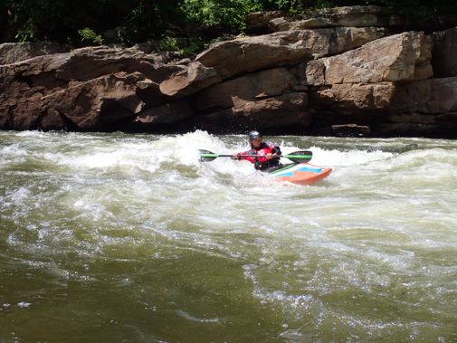 A kayaker surfs a hole on the Cheat River