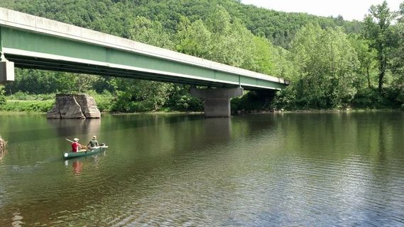 A canoe passing underneath the Saint George bridge on the Cheat River