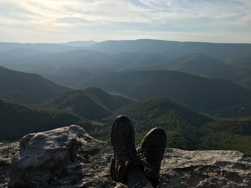 A backpacker takes a rest looking out from the top of North Fork Mountain 