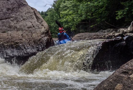 A kayaker prepares to launch over the drop on the Top Yough