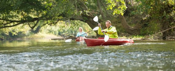 Two kayakers paddle down the Elk River