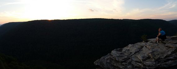 A person looks out over Blackwater Canyon at sunset