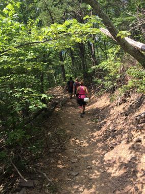 Hikers climb a steep trail near Seneca Rocks