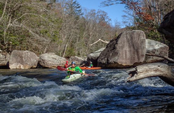 A kayaker paddles over a small drop on the Cranberry River
