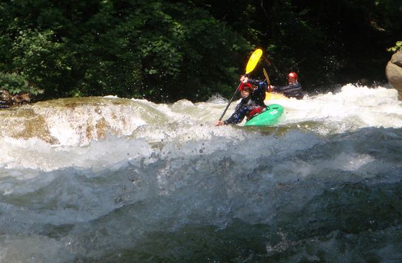 Two kayakers paddling down a Savage River rapid