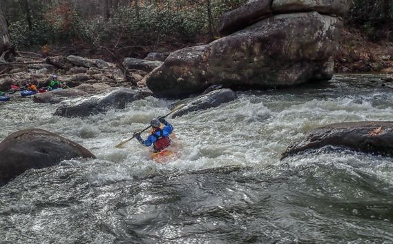 A kayaker paddles through a rapid on the Meadow River