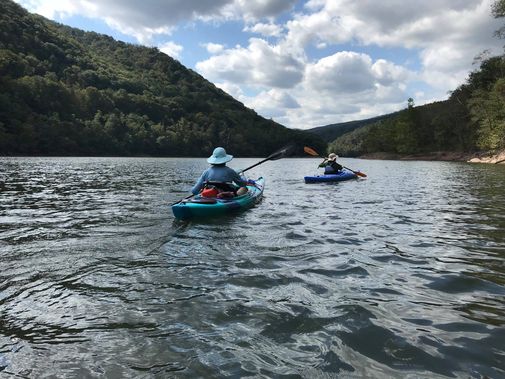 Kayaks paddle across the reservoir