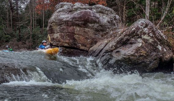 A kayaker paddles over a drop on the Middle Meadow River