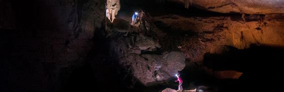 Two people exploring a cave in WV.