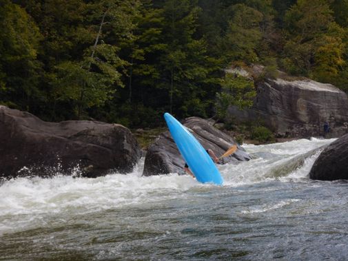 A kayaker does a cartwheel on the Upper Gauley
